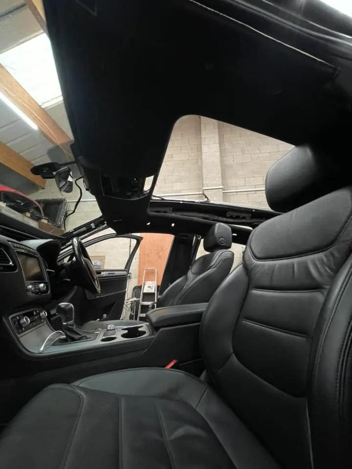 The interior of a car with black leather seats.
