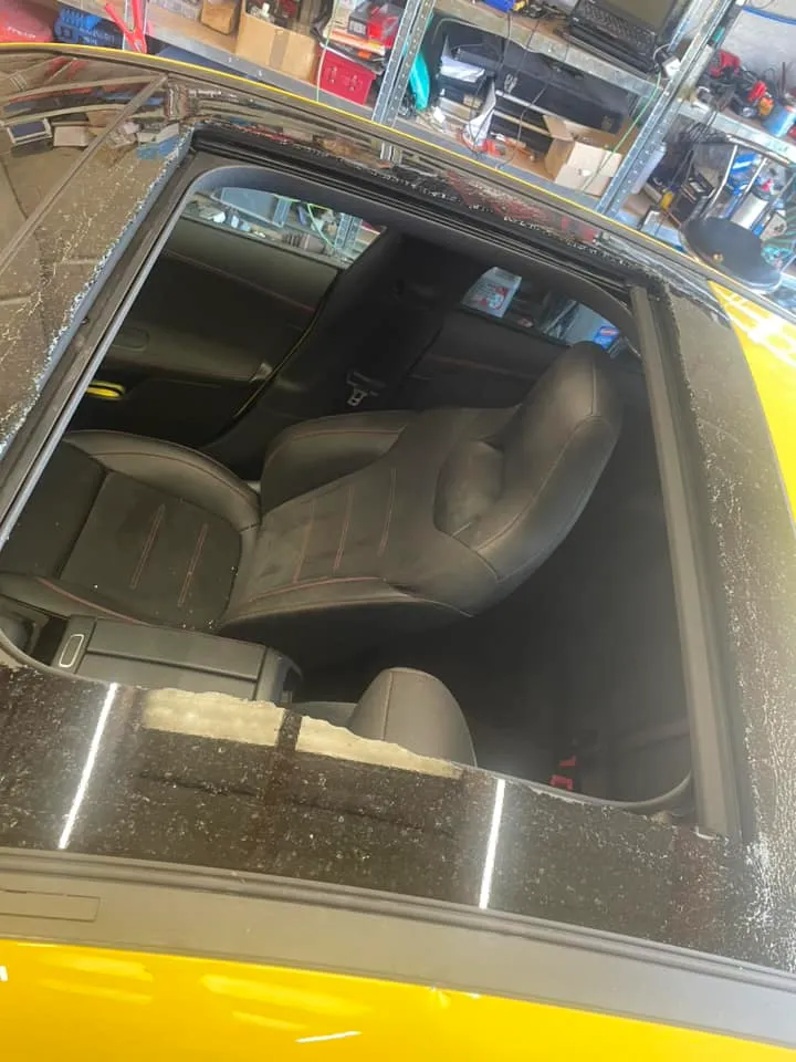 The interior of a car with the door open.