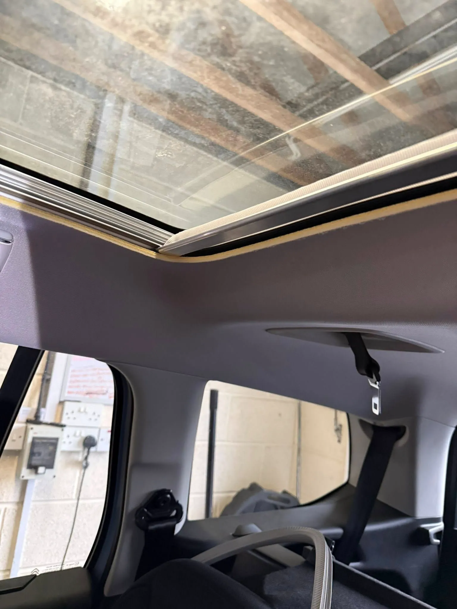 The interior of a car with a broken windshield.