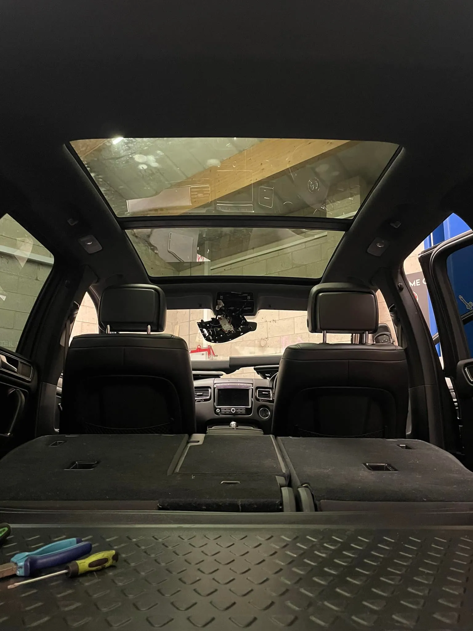 The back seats of a vehicle with a box in the back.